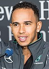 Lewis Hamilton speaking to the media at a car event