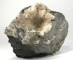 A pocket of hairlike acicular crystals of mesolite growing off thomsonite