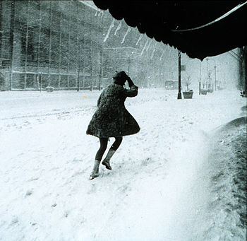 A resident struggles to walk in a blizzard in ...
