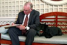 Photo of Armstong seated and writing something.