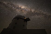 Photo of PRIME observatory with the galactic bulge in the background.