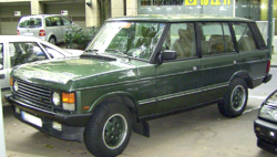 The post-facelift Range Rover, such as this early 1990s four-door example, had front skirts and a grille with horizontal slats.