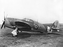A Royal Air Force P-47 with its raked-forward main gear, and rearward-angled main wheel position (when retracted) indicated by the just-visible open wheel door Republic P- 47D Thunderbolt ExCC.jpg
