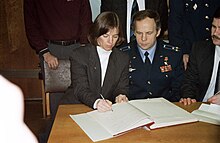 In keeping with Russian tradition, astronaut Dunbar (left), signs the diary of the late Yuri Gagarin, the first cosmonaut. Her STS-71 crew mates Anatoly Solovyev (center) and Nikolai Budarin, look on. S95-04325 Astronauts and cosmonauts sign Gagarin's diary.jpg