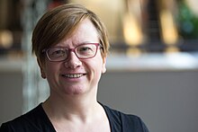 A portrait of Sandra Fauconnier smiling.