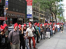 Клиенты в петушиных шляпах ждут в очереди перед запуском мероприятия Scribblenauts.
