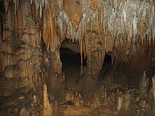 Photograph inside a cavern with stalactites and stalagmites