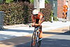 Male cyclist during race on his bicycle in colorful orange racing outfit
