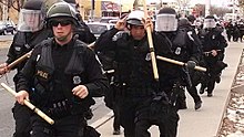 Albuquerque Police Department riot officers in 2014. Among the powers of LEAs are the use of force to conduct arrests and quell violence and unrest. APD TACTICAL COPS.jpg