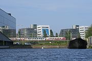 Trans Europ Express train seen from the Oostenburgervaart; INIT building on the left