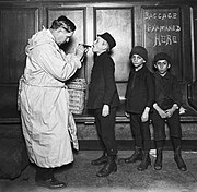 Immigrant children being examined by city health officer upon arrival at the battery from Ellis Island during Typhus Scare.jpg