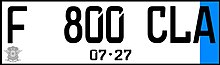 Example of a personalized electric vehicle numberplate in latest white-black color. Note the blue trim is on the side rather than horizontal on the bottom. Indonesian personalized electric vehicle numberplate white.jpg