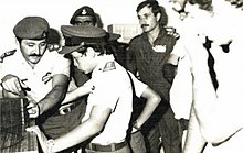 Abdullah, age 11, in uniform with soldiers