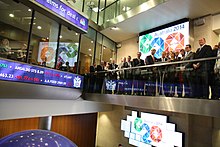 Stock exchanges, characteristic features of the top global cities, are interconnected hubs for capital. Here, a delegation from Australia visits the London Stock Exchange. London Stock Exchange (13056321704).jpg