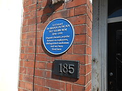 The blue plaque located at the front door of its former residence at Queens Road, Beeston.