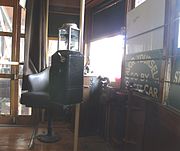 Front inside view of historic Trolley Car #116 . The trolley, built in 1928, is one of the original trolley’s to serve in Phoenix’s trolley system. It served the city until 1947. Pictured is a restored farebox. The trolley is on exhibit in the Phoenix Trolley Museum located at 25 Culver St.