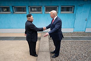 Trump and North Korea's Communist Party leader Kim Jong Un shake hands at the Korean Demilitarized Zone, June 30, 2019. President Trump Meets with Chairman Kim Jong Un (48162628746).jpg