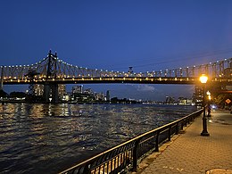 Queensboro Bridge at dusk, as seen from East River Greenway in Manhattan, 2020 Queensboro Bridge from East River Greenway.jpg