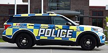 A Ford Police Interceptor Utility used by the St. Thomas Police Service, with a Battenburg marking design along the side of the vehicle for better visibility St. Thomas Police Cruiser.jpg