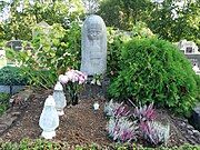 Apučių kapas, papuoštas balta skulptūra