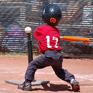 English: A right-handed tee ball player swings...