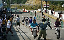 young Japanese woman and men cycle to celebrate "Sports Day" in Fukushima