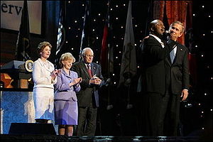 President George W. Bush puts his arm around S...