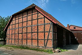Square-panel half-timbering with fired brick infill: Square paneling is typical of the Low German house, and is found in England.