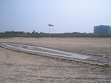Current marker at the disaster site, shown with Hangar No. 1 in background Hindenburg memorial.jpg