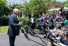 Trump speaks to reporters on the White House South Lawn in June 2019. President Trump in Iowa (48051727941).jpg