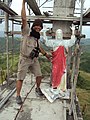 Joseph Alaban artistic adviser and brother of the sculptor inspects the 4 feet high replica of the giant statue.