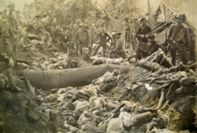 U.S. soldiers pose with Moro dead after the Moro Crater massacre in 1906. Bud Dajo Massacre Trench on Jolo Island c1906.png