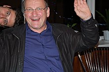 Karl Stetter sitting, smiling and waving