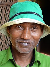 A Bengali man wearing a bucket hat Man in Hat - Srimangal - Sylhet Division - Bangladesh (12907514444).jpg