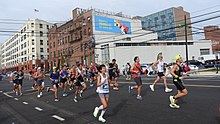 Group of runners with buildings in the background