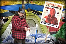 Example of a sign used during the Occupy Wall Street movement Occupy Wall Street 11 11 11 DMGAINES Demonstrator 4899.jpg