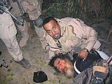 Saddam Hussein being pulled from his hideaway in Operation Red Dawn, 13 December 2003 SaddamSpiderHole.jpg