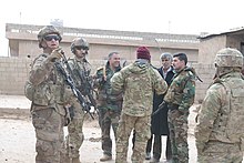 U.S. soldiers converse with pro-Syrian government militia near Qamishli, 12 February 2020 Coalition forces repel attack, February 2020.jpg