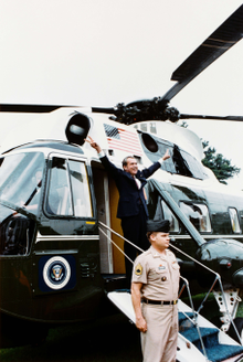 Nixon displays the V-for-victory sign as he departs the White House after resigning the presidency on August 9, 1974. Nixon-depart.png