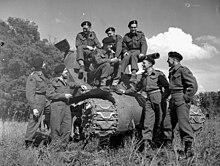 Members of the Sherbrooke Fusiliers Regiment in service dress uniform, June 1945 Personnel with the Sherman tank "Bomb" of the Sherbrooke Fusiliers Regiment, which landed in France on D-Day and continued in action through to VE-Day. Zutphen, Netherlands, 8 June 1945.jpg