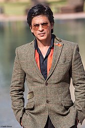 Shah Rukh Khan posing outside at a film festival