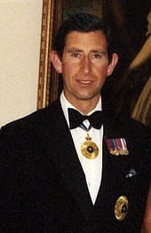 King Charles III (then Prince of Wales) wearing the insignia of a Knight of the Order of Australia, 1983 The Prince of Wales in Brisbane, 1983.jpg