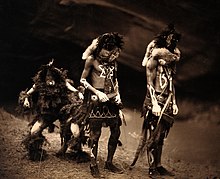 Navajo men dressed as To Neinilii, Tobadzischini, Nayenezgani (1904) Three Navajo men proceeding as war gods. Wellcome V0038486.jpg