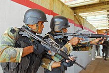 Dominican soldiers training in Santo Domingo Two Commando soldiers of the MEFA provide security.jpg