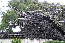 Chinese dragon sculpture. Wall roof modelled as a dragon (Yu Yuan Gardens, Shanghai, China).jpg