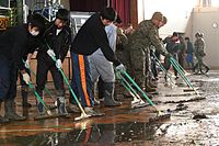 東日本大震災後日本學生和自衛隊與美軍打掃校園（校園打掃為日本公民教育活動之一[23]）。