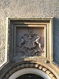 The Abercromby coat of arms is also inset above the doorway of the lodge house