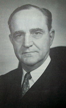The face of a middle-aged Sherman Minton with dark hair and a prominent nose looking directly forward with a slight smile