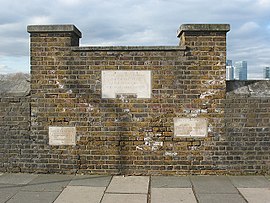 Thames flood level markers at Trinity Hospital Greenwich.jpg