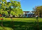 This old house possesses a special kind of charm and mysteriousness, because it stands concealed behind a white wall and an extensive garden with lofty oak-trees, luxuriant shrubs, lawns and flowers. The houses are good examples of the architecture in Stellenbosch between the 18th and 19th centuries and are also of historical interest. They have been restored by Historic Houses Limited and lend a particular character to the town of Stellenbosch.